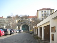 Západní portál bývalého železničního tunelu, vlevo je vstup na parkány.