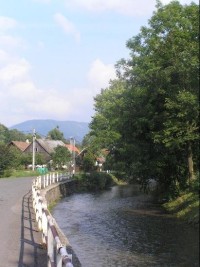 Tichá: Cesta směrem na Kunčice pod Ondřejníkem, vpravo řeka Tichávka, v pozadí pohled na vesnici
