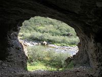 V jeskyni je okénkem vidět řeka