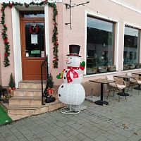 milý snehuliak pred obchodom sa snaží priôlákať zákazníkov