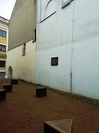 na budove synagógy tabuľa so stručným popisom histórie, žltá budova bývalé sídlo židovskej samosprávy, dnes patrí Cirkvi československej husitskej