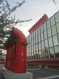 červené vetracie rúry oživujú budovu a jej okolie