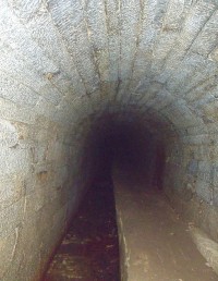 Vlevo od chodníčku na fotce vidíme protékající vodu z podzemní části kanálu